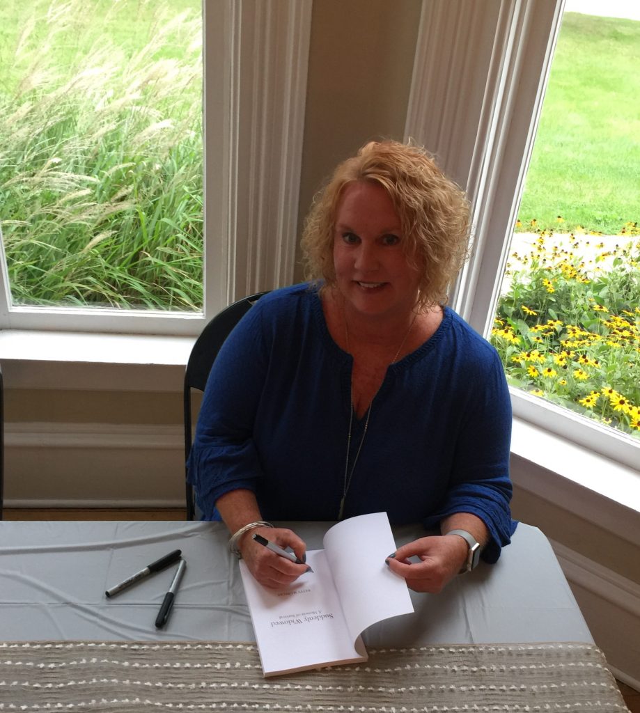 Patty Slupecki signing a copy of Suddenly Widowed